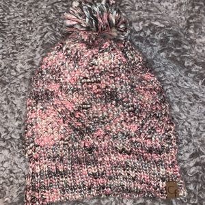 Pink nitted hat with fluffy ball